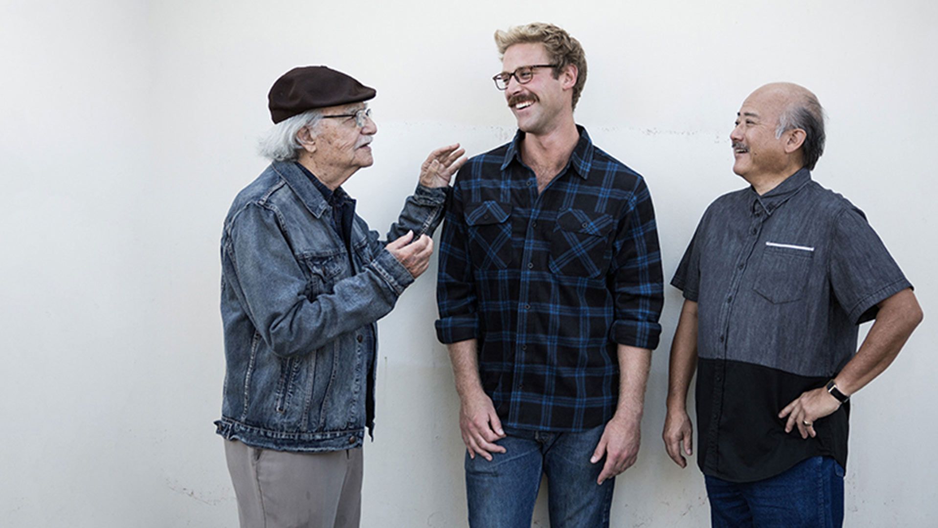 Photo of three men of various ages talking about their health.